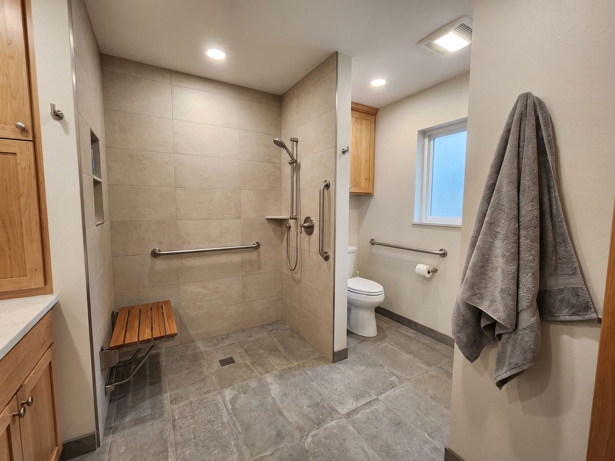 Bathroom made safer for aging in place with grab bars and a walk-in shower