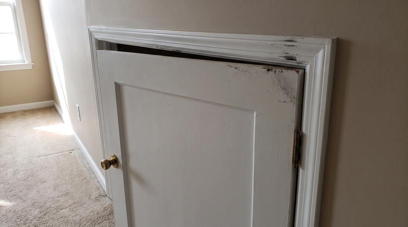 A worn interior door before repair