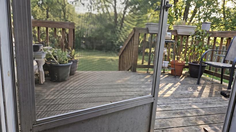 The same screen door re-screened and back on its track