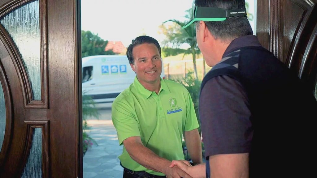 Kaminskiy technician greeting a San Diego homeowner at the door