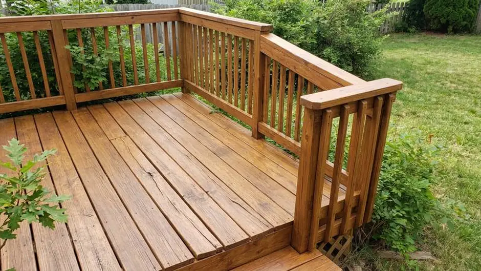 After: boards replaced, railing solid, deck sealed