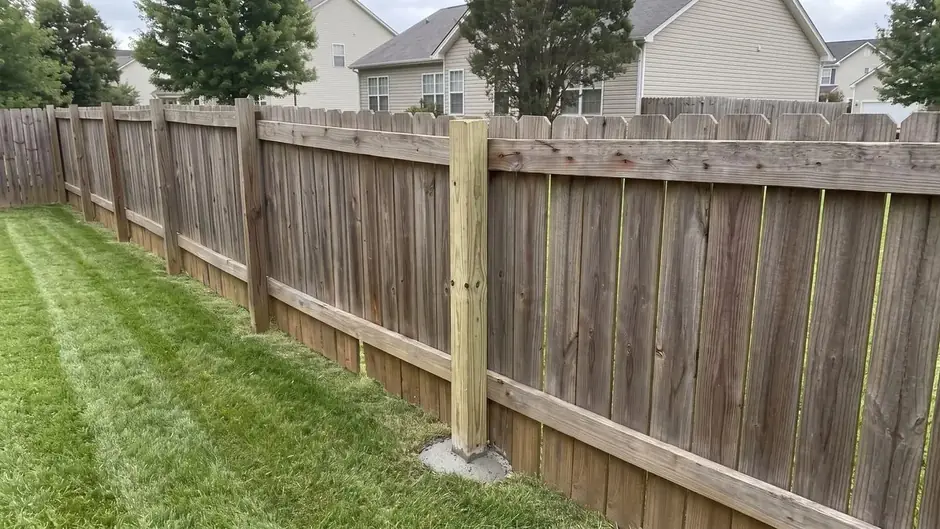 After: a new post set and the fence line straight