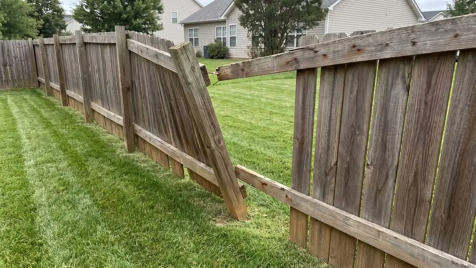 Before: a leaning fence on a rotted post