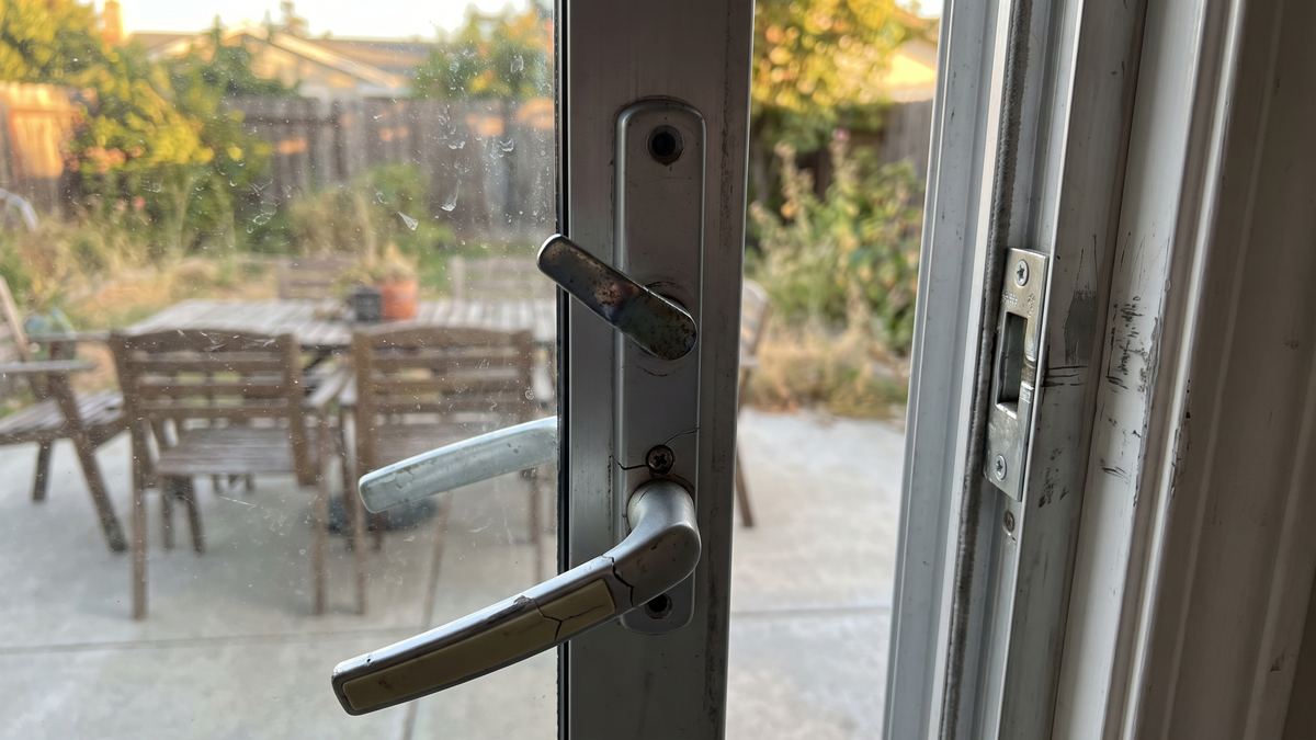Worn, cracked patio door handle before repair