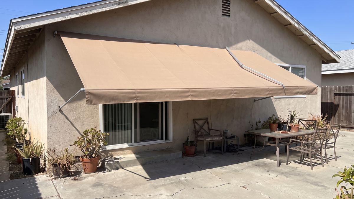 A new fabric awning mounted over a patio door