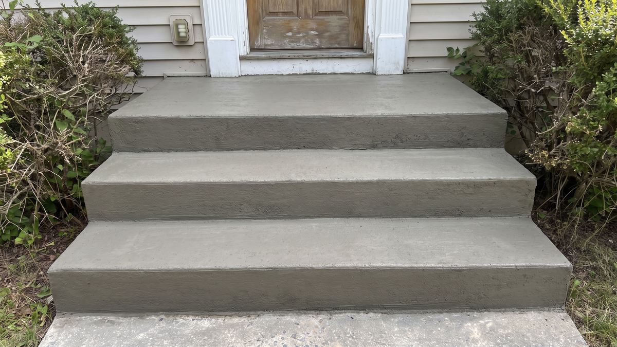 A repaired brick step with fresh matching mortar joints