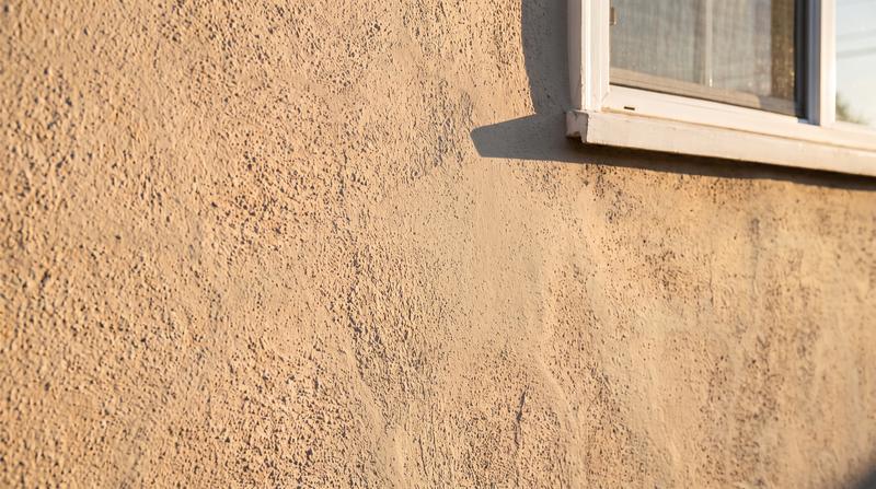 The same stucco wall repaired smooth by Kaminskiy