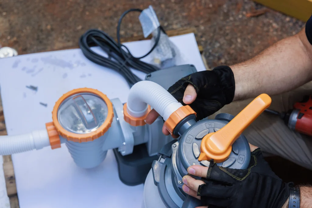 Hands Assembling A Sand filter pump for a swimming 2026, 05, 07, 20, 07, 14 utc
